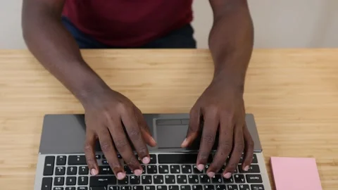 Close up of african american user hands typing on laptop keyboard sitting at Stock Footage 157925155