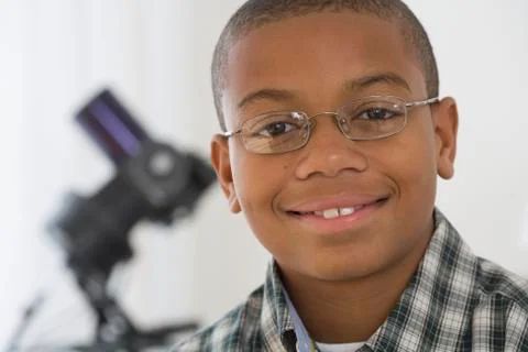 Close up of African boy with microscope in background Stock Photos
