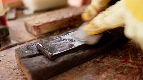 Close-up of African carpenter sharpening blade on workbench in workshop  Stock Footage 346733924