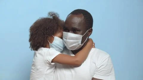 Close up african father and daughter in protective mask embracing isolated on Stock Photos