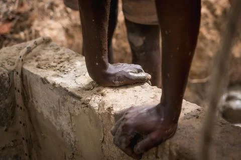 Close up of african hands at work in a construction site for a water well in Stockfoto's