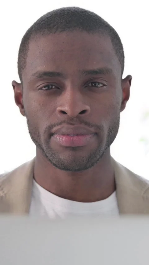 Close up of African Man with Laptop Looking in Camera, Vertical Video Stockbeeldmateriaal 337350165