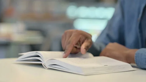 Close Up of African Man Reading Book Stock Footage 146480024