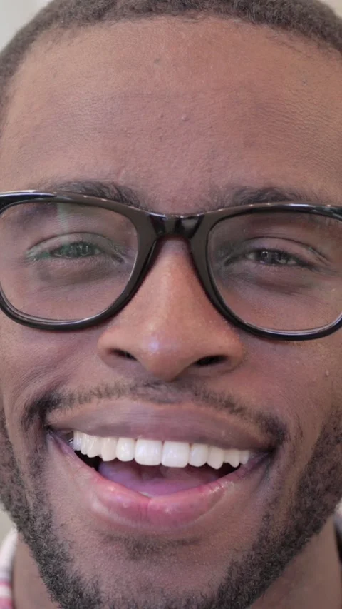 Close up of African Man Smiling at the Camera, Vertical Video Stock Footage 340041175