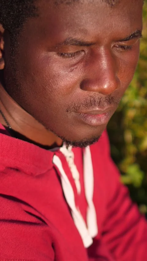 Close up of African man turning toward camera asking for help silently Stock Footage 335696213