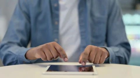 Close Up of African Man Typing on Tablet kept on Table Stock Footage 146481870