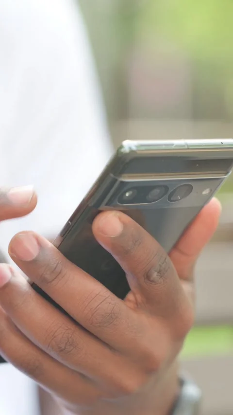Close up of African Man Using Smartphone Outdoor, Vertical Video Stock Footage 319022525
