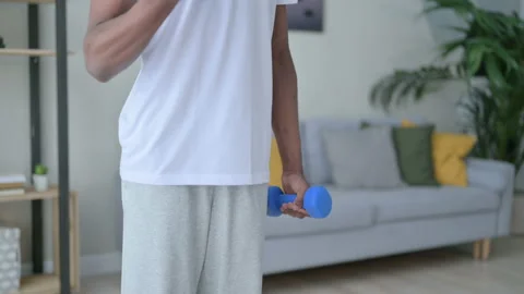 Close up of African Man Working out with Dumbbells at Home Stock Footage 154721153