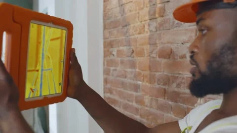 Close up of african professional worker doing analysis of heat on wall with Stock Footage 142220552