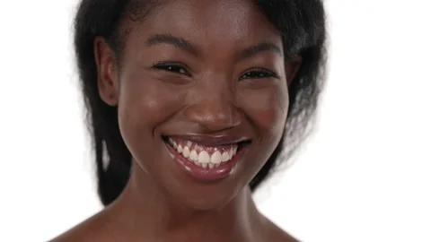 Close up of an african woman's face, smiling widely with her teeth, eyes and Stock-Footage 156573288
