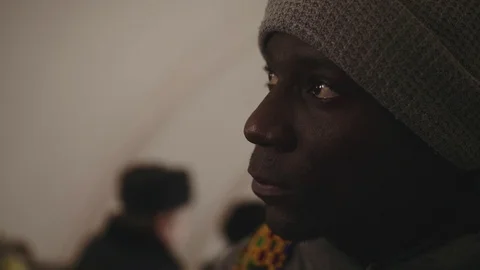 Close-up of african young man riding the subway on an escalator Stock Footage 102437636