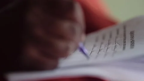 Close up afro american hand correcting homework or exam Stock Footage 148215158