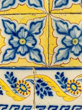 Close-up of aged ceramic wall tiles with traditional hand-painted blue and .. Stock Photos