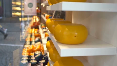 Close up of aged cheeses shot through a display case. Stock Footage 141360275