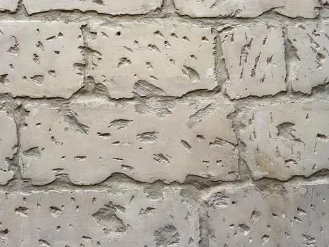 Close-up of aged limestone wall with visible erosion, cracks and chisel marks Stock Photos