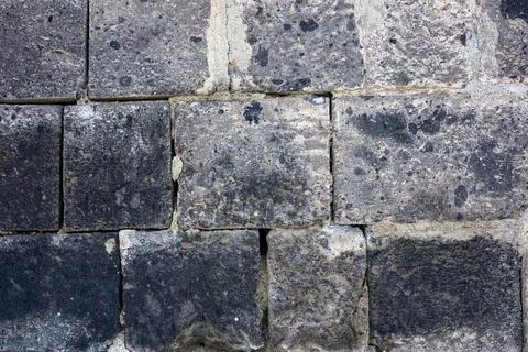 Close-up of aged stone blocks with visible mortar joints and surface wear Stock Photos