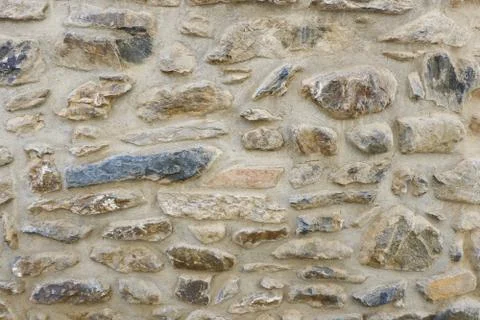 Close up on aged stone wall surface of grey colours Stock Photos