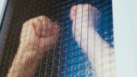 Close-up of aggressive man's hands hitting the door window 库存影片 317771750