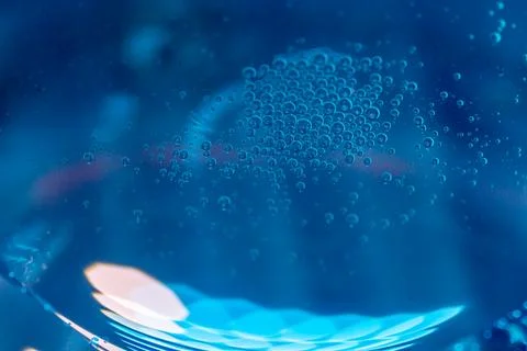 Close-up of air bubbles in blue liquid. Abstract texture, vibrant color, an.. Stock Photos