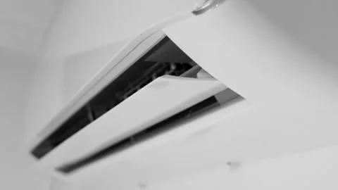 Close-up of an air conditioner with open vent flaps actively blowing air in.. Stock Footage 320736814