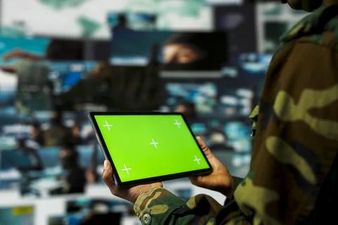 Close up of air defense command operator using green screen tablet Stock Photos