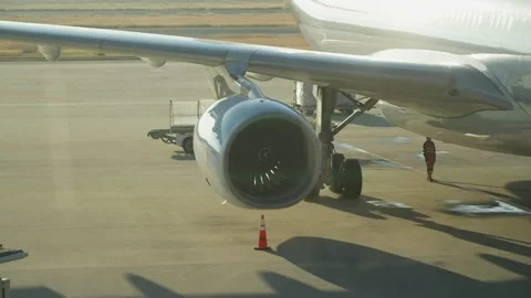 Close up of airplane engine and wing at airport in morning Stock Footage 325420682