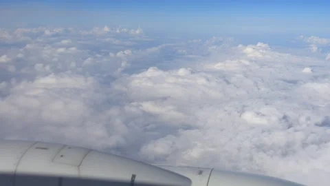 Close-up of an airplane engine with a view of clouds below, taken from the .. Stock Footage 294315418