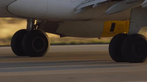 Close up of airplane landing gear rolling on runway Video stock 337800329
