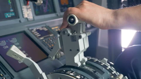 Close up of airplane pilot's hand regulating thrust lever handle for engine Stock Footage 93661307