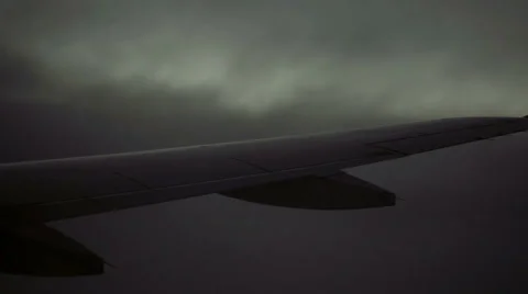 Close-up of airplane wing flying through dark clouds at night - storm sky in HD 스톡 동영상 67183887