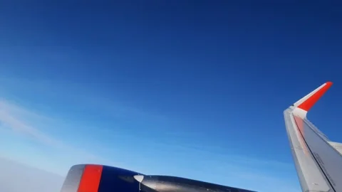 Close-up of an airplane wing isolated in the blue sky flies above the clouds Stock Footage 164555938