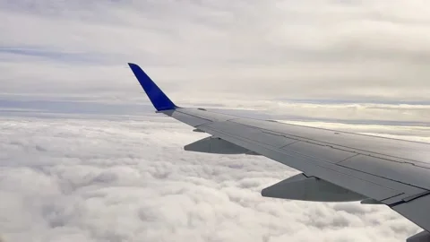 Close-up of airplane wing surface flying high over clouds. Travel and air Stock Footage 232442554