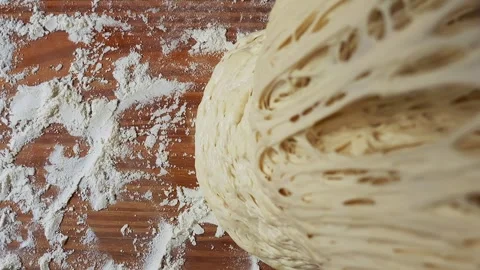 Close-up of airy, well-fermented dough with a porous texture lifted from a Stock Footage 303889523