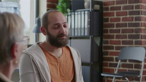 Close up of alcohol addict crying in front of people in circle at aa therapy Stock Footage 166114002