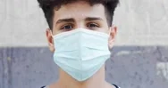 Close-Up Of An Algerian Afro Teenage Boy With Medical Mask On His Face Stock Footage
