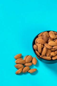 Close-up of Almonds on blue background Stock Photos