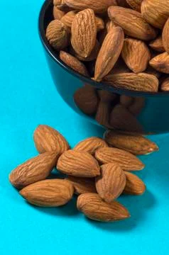 Close-up of Almonds on blue background Stock Photos