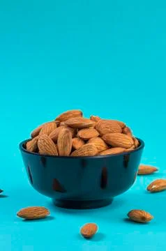 Close-up of Almonds on blue background Stock Photos