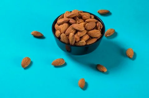 Close-up of Almonds on blue background Stock Photos