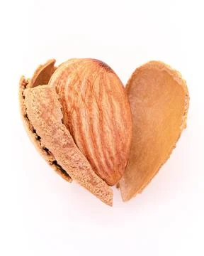 Close up almonds nut shell cracked in heart shape isolated on white backgroun Stock Photos