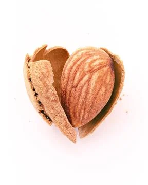 Close up almonds nut shell cracked in heart shape isolated on white backgro.. Stock Photos