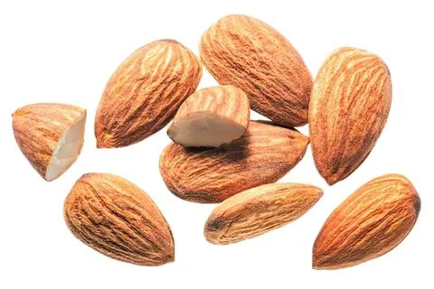 Close-up of almonds with one cracked open on white background Stock Photos