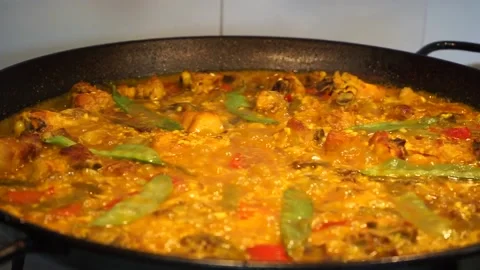 Close-up of the almost finished paella boiling little by little with all its Stock Footage 147988764