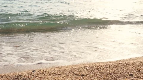 Close-up, along sandy beach, in foam of surf, female legs are walking. woman Stock Footage 136837125