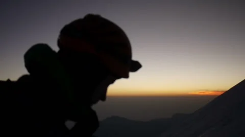 Close up of Alpine climber with headlamp and sunrise in the background Stock Footage 43248930