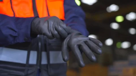Close up aman technician engineer wearing and adjust protective safety glove. Stockbeeldmateriaal 332119422
