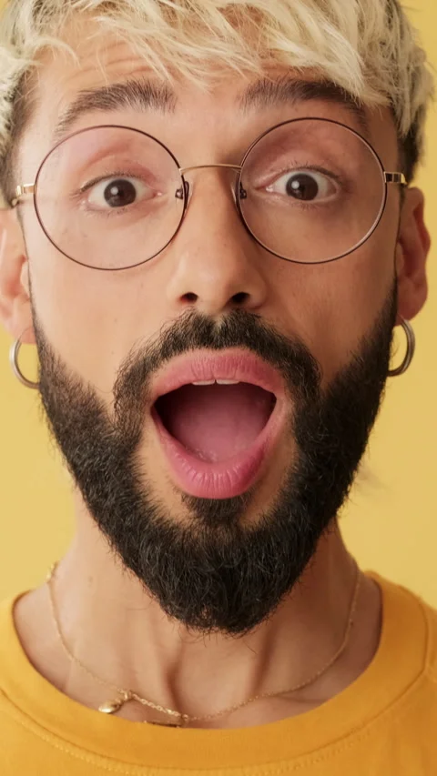 Close-up of amazed men looking at camera expressing wow isolated on yellow Video stock 253935777