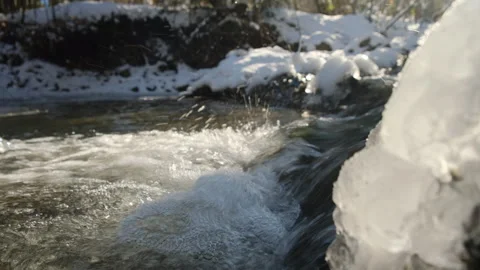 Close up of amazing winter river at warm sunny day. Crystal water in mountains Stock Footage 301076740