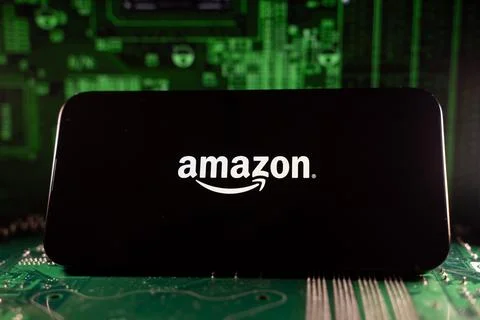 Close up of Amazon logo on device with circuit board background. Toronto, Canada Stock Photos