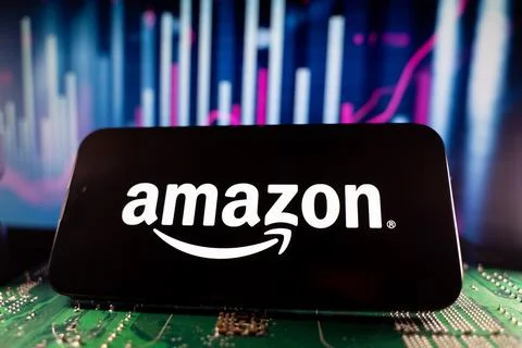 Close up of Amazon logo on smartphone screen with technology and financial chart Stock Photos